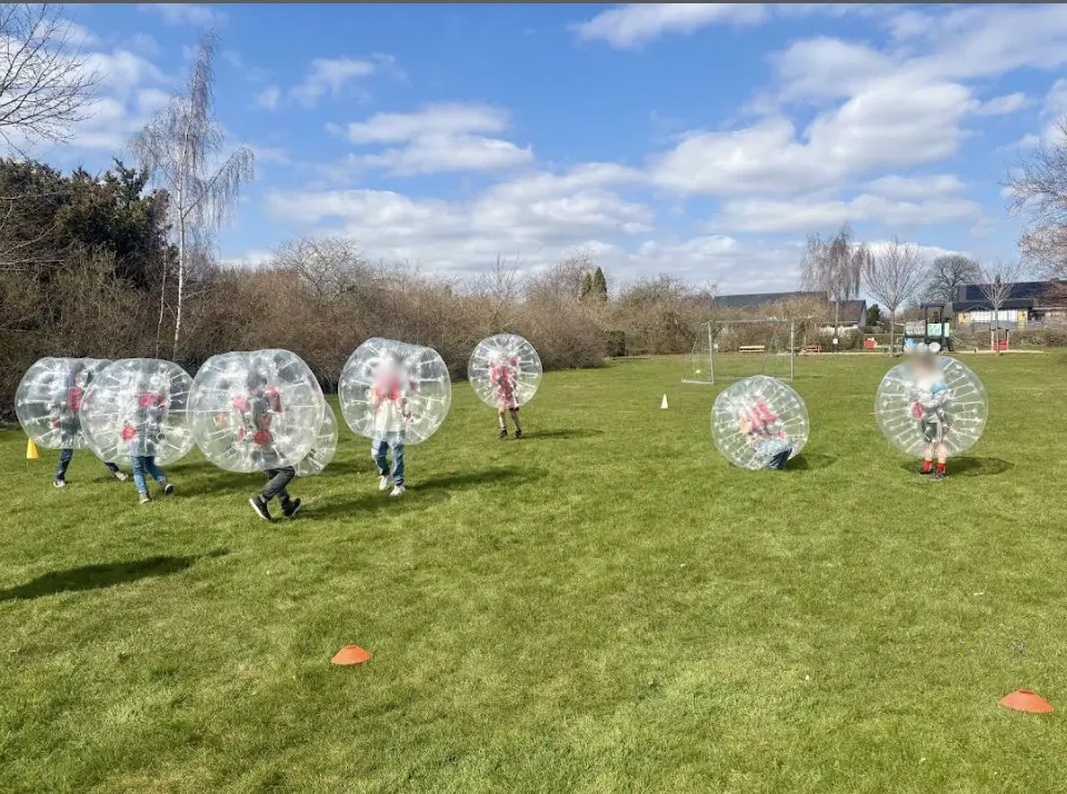 Barn spelar bumperballs på en gräsplan i Skåne